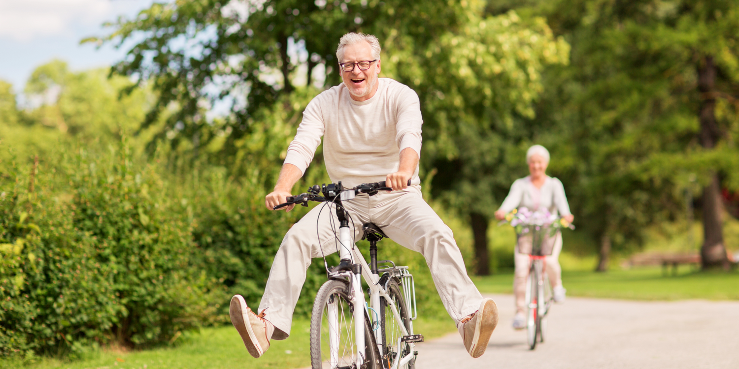 Happy older man cycling, enjoying a healthier life after quitting smoking